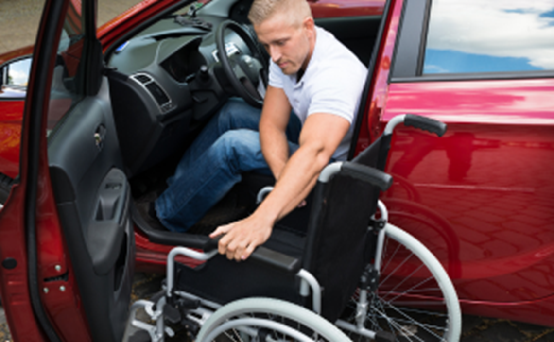 Wheelchair user getting in car